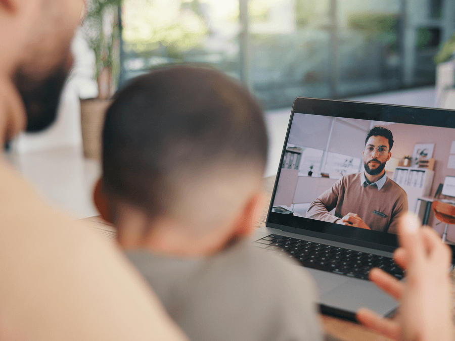 Dad and son on a video call with doctor